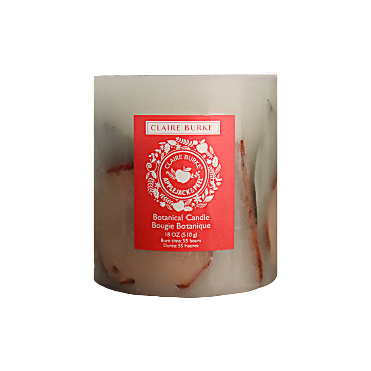 Featuring hand-arranged botanicals enveloping a center display of leafy greens, cinnamon sticks, and vibrant apple slices. The botanical candle is packed with the delightful aroma of Claire Burke's Applejack & Peel® scen